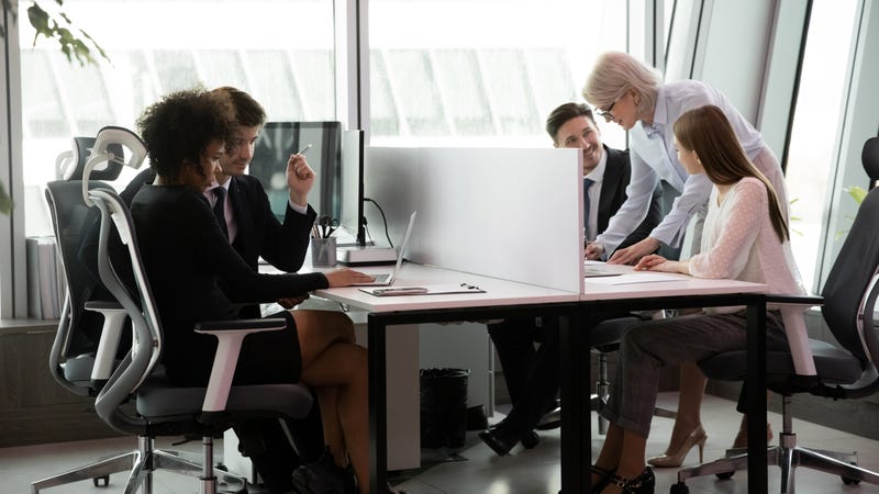 A group of people in an office looking at computer screens